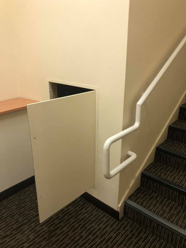 A small door next to a staircase. 